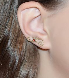 ⋙ 14kt Gold Filled garnet ear climber.⋙ This listing is for one ear climber.⋙ This climber is made of 20 gauge wire.⋙ Available gemstones: ruby; emerald; swiss blue topaz; light blue opal; kiwi green opal; black onyx; black-red opal; white pearl; blue sapphire; lapis lazuli; amethyst; clear white topaz; turquoise; garnet; white opal⋙ Measurements:⋙ The stone is 3mm in diameter⋙ ⋙ I will put your order into a beautiful jewelry box (it will be ready for gift giving). Elegant Gemstone Cartilage Earrings As Gift, Elegant Red Ear Cuff As Gift, Elegant Red Ear Cuff For Gift, Elegant Red Ear Cuff Gift, Elegant Gold Gemstone Cartilage Earrings, Elegant Gold Cartilage Earrings With Birthstone, Elegant Yellow Gold Internally Threaded Ear Cuff, Gold Elegant Cartilage Earrings With Birthstone, Ear Sweeps