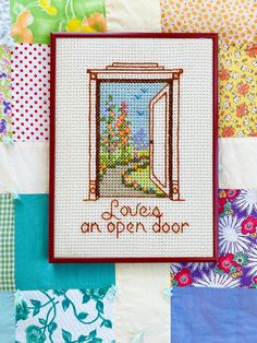 a cross - stitch card with the words love's an open door on it