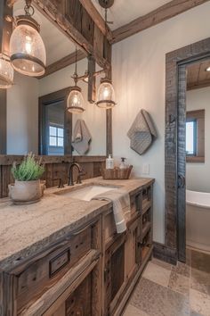 a large bathroom with two sinks and wooden fixtures on the counter top, along with hanging lights