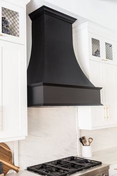 a black stove top oven sitting inside of a kitchen