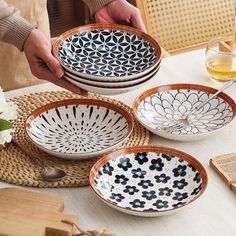 a person holding plates on top of a table