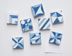 blue and white ceramic tiles are arranged on top of each other, including one in the middle