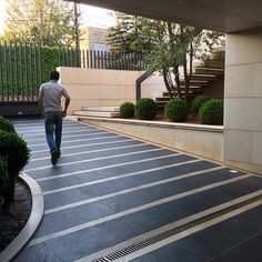 a man is walking down the street with his skateboard