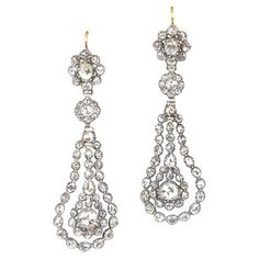 A lovely pair of antique diamond earrings with silver on gold mounting from the Georgian era, circa 1810. Each earring features a suspended antique pear-shaped rose-cut diamond, surrounded by a double oval halo of rose-cut diamonds. The total approximate diamond weight for the pair is 5 carats. Metal: Gold, Silver Stone: Diamond Stone Cut: Rose Cut Style: Georgian Measurements: 2.52 inches Antique Diamond Earrings, Earrings Fancy, Diamond Chandelier Earrings, Georgian Jewelry, Georgian Era, Sparkle Jewelry, Antique Diamond, Art Deco Jewelry, Jewelry Companies