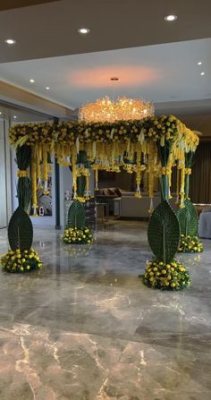 an elaborately decorated stage with flowers and chandelier