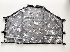 a black and white flowered cloth hanging on the wall