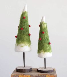 two small christmas trees sitting on top of each other