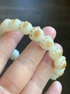 a close up of a person's hand holding a fake toothbrush with holes in it