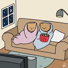 two teddy bears sitting on a couch watching tv