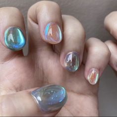 two hands with different colored nail designs on them