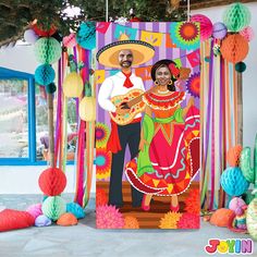 an image of a mexican couple on the dance floor with paper decorations around him and her