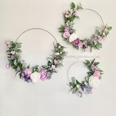 two circular wreaths with flowers and greenery