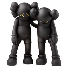 two black toy figures are standing next to each other with their arms around one another