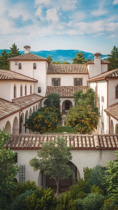 an artist's rendering of a courtyard with orange trees and mountains in the background