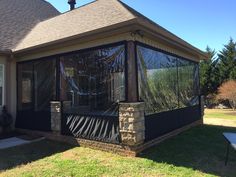 a house with a screened porch in the front yard