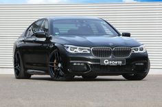 a black bmw car parked in front of a building with the words g - power written on it