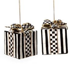 two black and white boxes with bows hanging from them