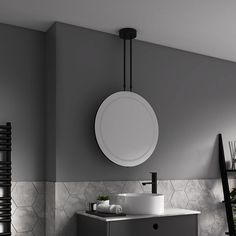 a bathroom with a sink, mirror and radiator in the wall next to it