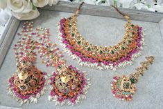 Nauratan Multi Necklace Set  With Statement Jhumer, Tikka and Jhumkey Main colour is Green, Orange and Pink  with a combination of other colours. Stunning Set perfect for a Mehndi Function Luxury Colorful Beads Jewelry For Festival, Luxury Bridal Necklace With Peacock Design For Diwali, Affordable Meenakari Jewelry For Festive Season, Luxury Zari Work Tikka For Festive Season, Multicolor Intricate Design Necklace For Wedding, Festive Multicolor Tikka For Celebration, Multicolor Bridal Necklace With Latkans For Diwali, Traditional Luxury Multicolor Jewelry, Cheap Festive Meenakari Jewelry