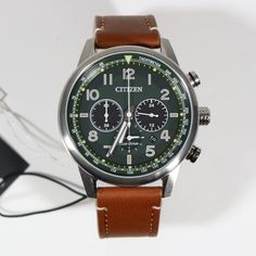 Item No. CA4420-21X Citizen Eco-Drive Green Dial Stainless Steel Brown Leather Strap Men's Watch CA4420-21X Watch features: Eco Drive Movement Caliber B620 Stainless Steel Case Brown Leather Strap Date Display Analog Display Luminous Markers Luminous Hands Chronograph Function Push Pull Crown Mineral Crystal Water Resistance: 100 Meters Lug Width: 20 mm Case Diameter: 43.1 mm Case Thickness: 12.5 mm Free Priority Shipping on all orders in continental U.S. Shipping time is usually between 2 and 6 Brown Analog Chronograph Watch For Outdoor, Outdoor Brown Analog Chronograph Watch, Green Chronograph Watch With Analog Display For Business, Business Chronograph Watch With Green Analog Display, Business Green Chronograph Watch With Analog Display, Green Leather Watches With Subdials, Green Automatic Chronograph Watch For Business, Green Leather Chronograph Watch, Modern Green Leather Watches