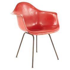 a red chair with metal legs on a white background