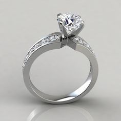 a diamond engagement ring on a white background