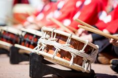 there are many wooden drums lined up on the ground