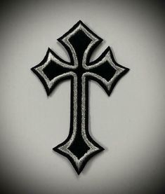 a black and silver cross on a white background