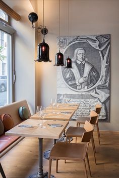 a long table with chairs in front of a painting on the wall