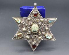 I am offering this vintage Turkmen judaica David star tribal alpaka unique pendant. it is hand made with beautiful Turquoise stones, glass beads and partial gold wash with star shape. Thanks for taking the time to look and please contact for further pictures or info. Measures, Weight : 67.2 grams Length : 10.5cm ( 4.1" ) Width : 10cm ( 3.9" ) Pictures can be slightly light difference, Please know what you are bidding on. The metal of Most Kuchi, Afghan and Turkoman items are called with differen David Star, Gold Wash, Turquoise Stones, German Silver, Unique Pendant, Star Pendant, Stone Pendant, Star Shape, Making Jewelry