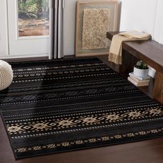 a black and gold rug in front of a door