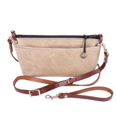 ◄Details This convenient size is ideal for keeping essentials together in a larger bag for the big haul. Then taking only what you need when you're out and about. Wear it crossbody for shopping, work, school, or travel. Or convert it to a wristlet for a day or night out. NEW Adventure leather is rugged yet soft and sophisticated. Dimensions: 9.75" W x 5.5" H x 2" Adjustable detachable Cross-body Strap: 57" - 49" Plus a detachable wristlet strap option Exterior back pocket, perfect for your phone Interior zippered divider pocket ◄The Leather Leather: Adventure Color: DesertOur charming Adventure leather is both resilient and beautiful with a soft, pebbled texture. Rustic yet sophisticated, its slightly buffed surface has a lovely natural two-toned effect and is very easy to care for. Small Everyday Crossbody Satchel With Cell Phone Pocket, Everyday Satchel Bag With Cell Phone Pocket, Beige Satchel With Cell Phone Pocket For Travel, Everyday Satchel Clutch With Zipper Closure, Everyday Clutch Shoulder Bag With Zipper, Versatile Satchel With Cell Phone Pocket For Everyday Use, Everyday Crossbody Shoulder Bag With Cell Phone Pocket, Everyday Crossbody Bag With Cell Phone Pocket, Everyday Beige Bag With Cell Phone Pocket