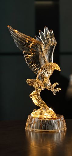 an eagle figurine sitting on top of a wooden table