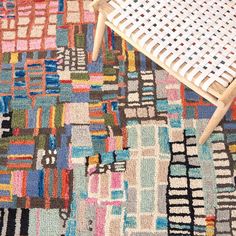 a chair sitting on top of a colorful rug