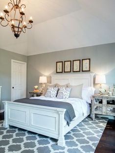 a white bed sitting in a bedroom on top of a gray and white carpeted floor