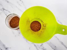 two jars filled with brown stuff sitting on top of a marble counter