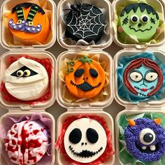 twelve decorated cupcakes in plastic containers with faces and decorations on them for halloween