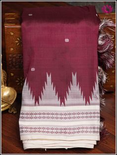 Berhampuri silk was introduced at Berhampur town in 14th century AD by the Mohuri Kings. It is known as ‘Silk City’ for its pure silk weaves. This Berhampuri silk saree is one of the traditional weaving and handloom heritage from Odisha. Experience class and elegance with this Maroon and Half white Berhampuri double pallu pure silk saree with phoda kumba(temple) borders. Extended double pallu in Half white and custom hanmade tassels on pallu adds grace to the saree. Part of the package is an uns White Traditional Wear With Woven Motifs For Diwali, White Traditional Wear With Woven Motifs For Ceremonies, Ceremonial White Traditional Wear With Woven Motifs, White Traditional Wear With Woven Motifs For Navratri, White Saree With Woven Motifs For Traditional Ceremonies, Ceremonial White Traditional Wear With Weaving Work, Traditional Katan Silk Saree With Woven Motifs, White Tussar Silk Dupatta With Woven Motifs, White Saree With Woven Motifs In Traditional Drape