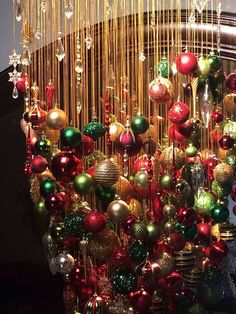 a bunch of christmas ornaments hanging from the ceiling