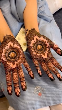 two hands with henna designs on them