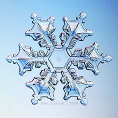 a snowflake that looks like it has been cut into smaller pieces and is in the air