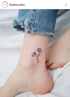 a small flower tattoo on the ankle