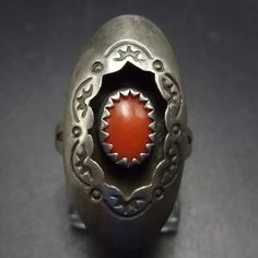 SIGNED NAVAJO RED MEDITERRANEAN CORAL STERLING SILVER SHADOWBOX RING DESCRIPTION:  This ring will be a treasured addition to your collection of fine vintage Southwestern and Native American jewelry. MEASUREMENTS:  Ring face measures 1 1/8" x 1/2" RING SIZE: 5 1/2 WEIGHT: 3.4 grams SIGNED:  AR conjoined, over right facing curved arrow  STERLING:  yes, stamped STERLING Vintage Silver Concho Ring, Vintage Concho Ring Jewelry, Western Style Oval Rings For Gift, Southwestern Concho Ring As A Gift, Southwestern Concho Rings As Gifts, Southwestern Style Concho Rings As Gifts, Western Style Concho Rings For Gift, Western Style Concho Rings As A Gift, Vintage Adjustable Concho Rings