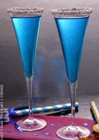 two blue wine glasses sitting on top of a table