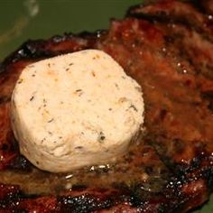 a piece of meat sitting on top of a green plate