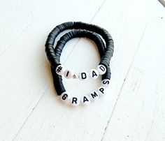 two black and white beaded bracelets with the words rida's gramps on them