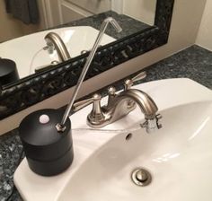 a bathroom sink with a soap dispenser on the counter next to it