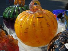 several glass pumpkins are on display for sale