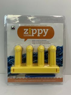 three yellow plastic toothbrushes sitting on top of each other in front of a package