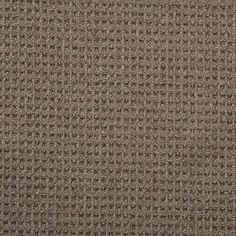 an upholstered brown and black fabric textured with small squares on the surface